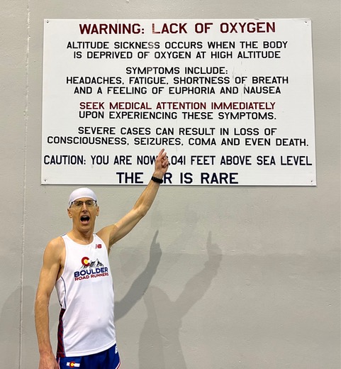 Tim Degrado points to a sign describing the Lack of Oxygen at the USAFA in Colorado Springs while competing